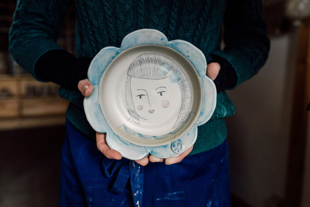 handmade pottery with a face on a plate