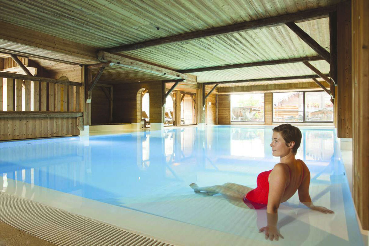 Woman in a spa and indoor swimming pool in Les Gets