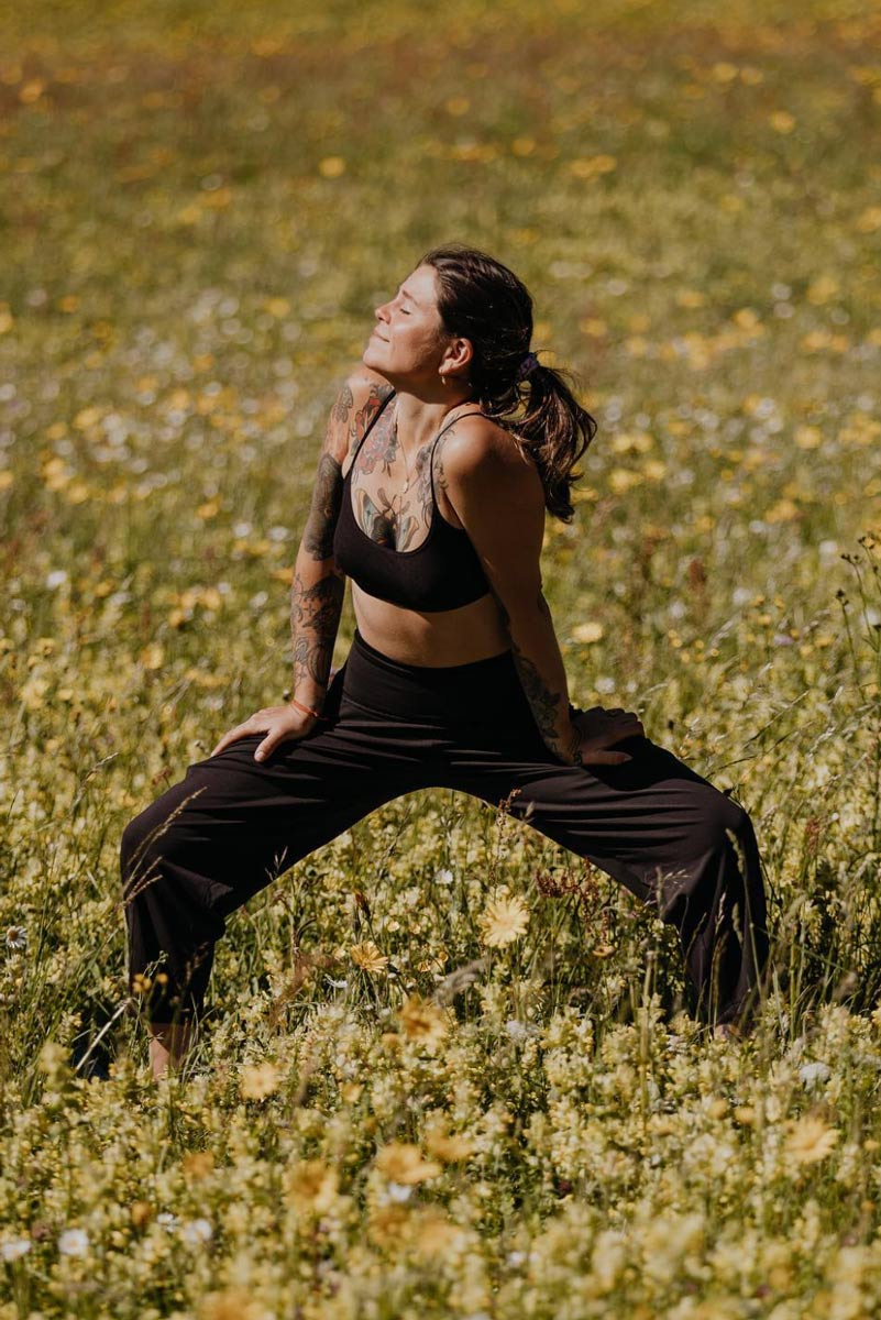 Romana Maria Schwaiger practicing yoga outside in nature in styria