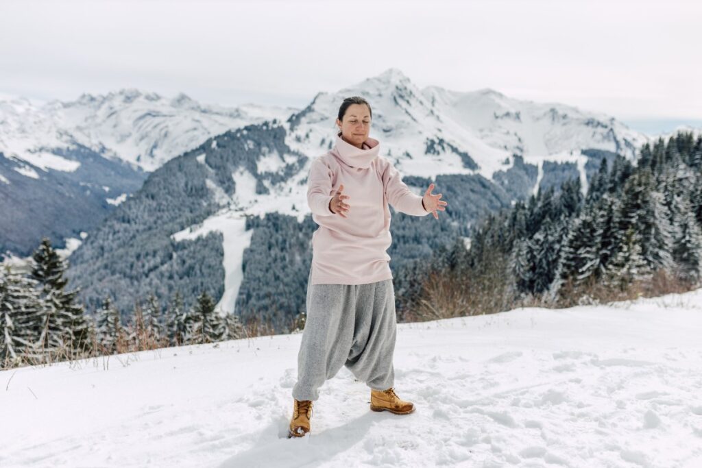 compressing hte ball of qi gong movement done at the top of a snowy mountain