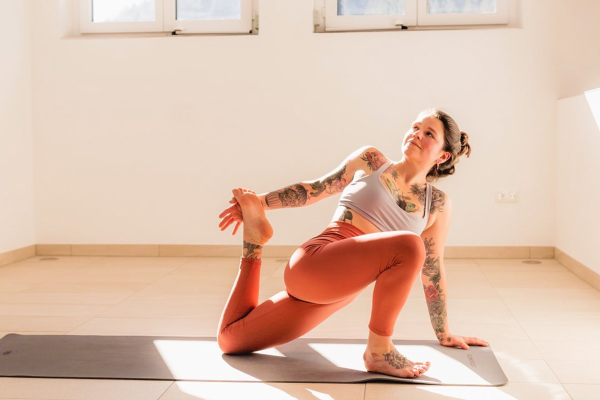 yoga teacher Romana Maria Schwaiger practicing inside in a studio in austria