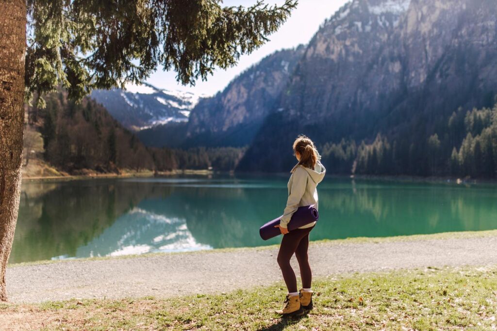 yoga by mountain lake in the Alps
