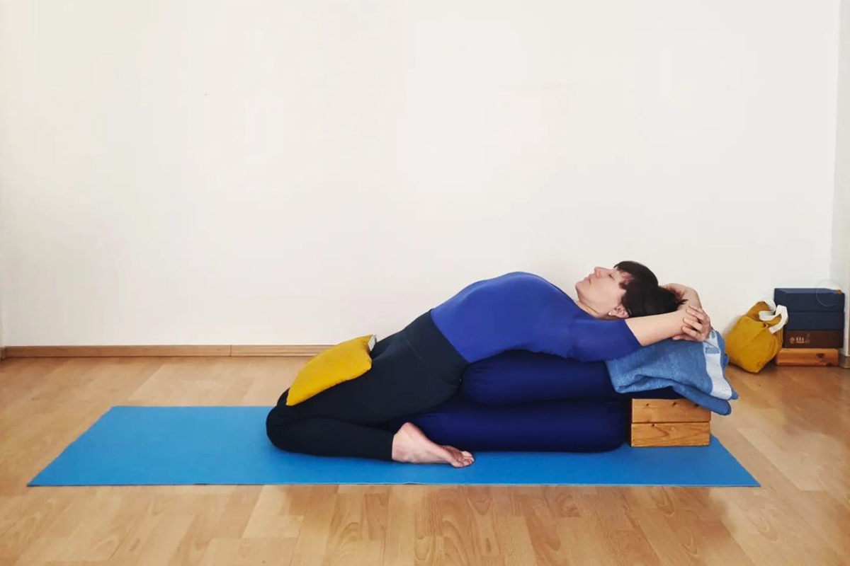 Restorative iyengar yoga being practised by Claudia Lamas Cornejo