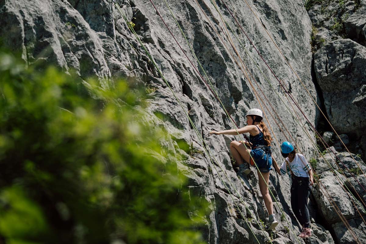 mother and daughter doing rock climbing on a retreat in the French Alps in Summer