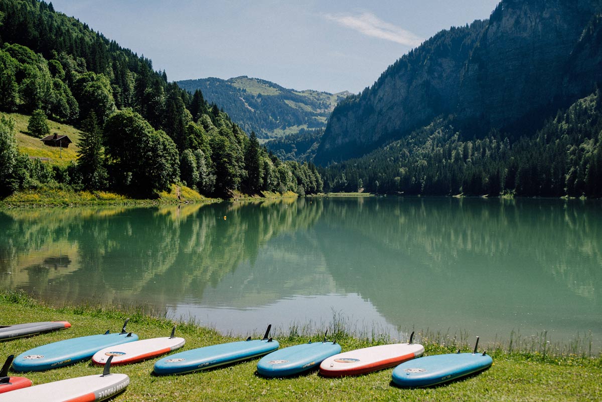 Stand up paddle boards in front of Lake Montriond in the French Alps