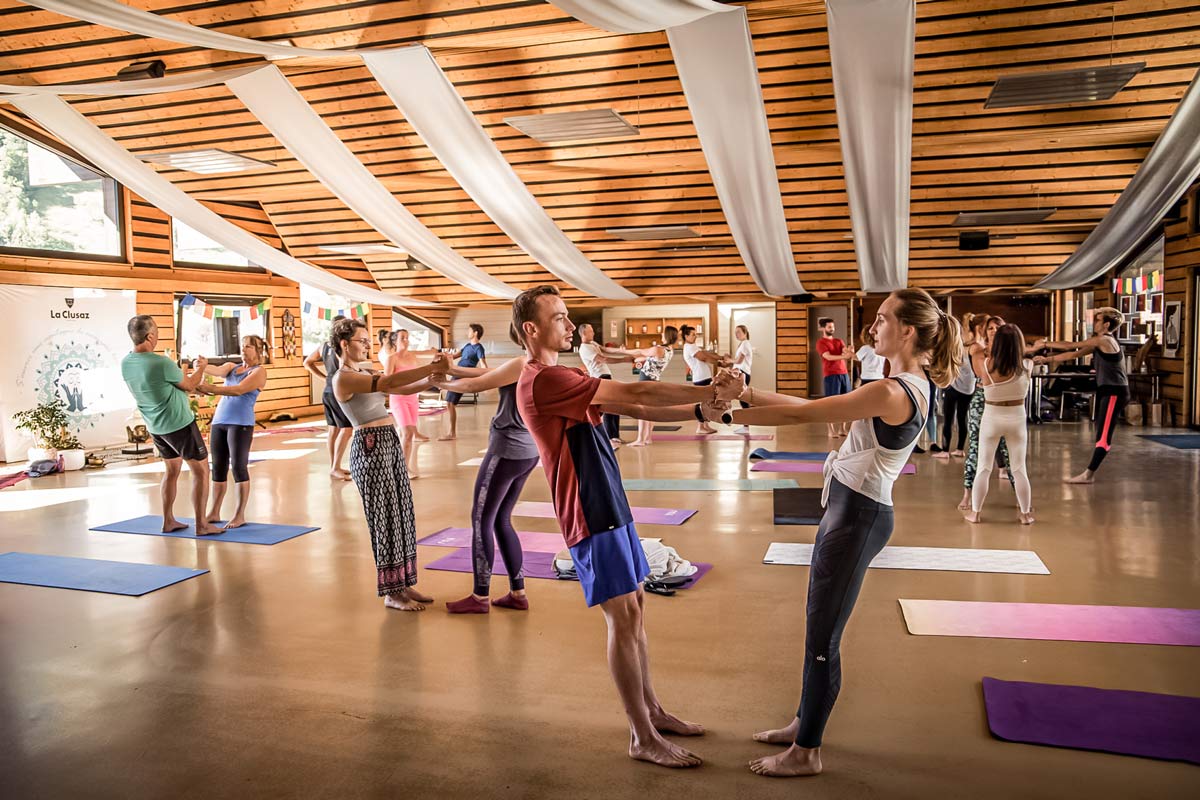 Indoor Acro yoga class at La Clusaz Yoga Festival in the Village Hall