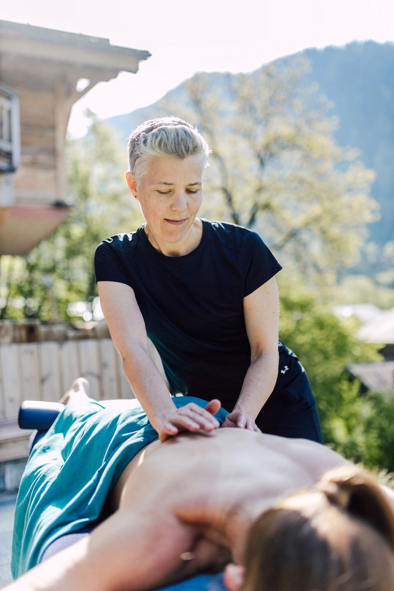 Kristina from Alpine Body Care Massage giving a deep tissue massage outside in the Alps